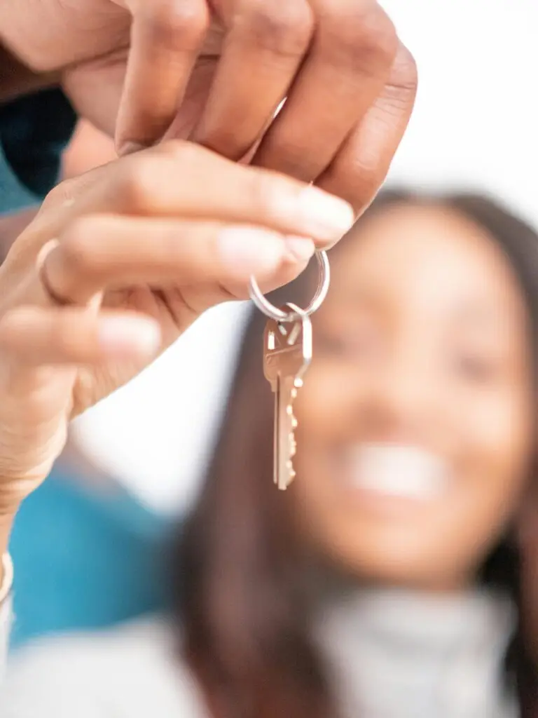 Joyful moment of new homeowners receiving keys to their new house, symbolizing hope and new beginnings.